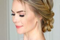 a braided side halo with a braided low bun and some locks down for a rustic or boho bride