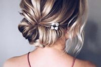 a casual updo with a twisted low bun and a bump plus some locks down