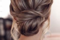 a chic fishtail braid low un with a messy volume on top and some locks down is amazing