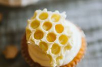 a cupcake topped with frosting and honeycombs is a gorgeous dessert for a wedding, pair it up with a honeycomb wedding cake