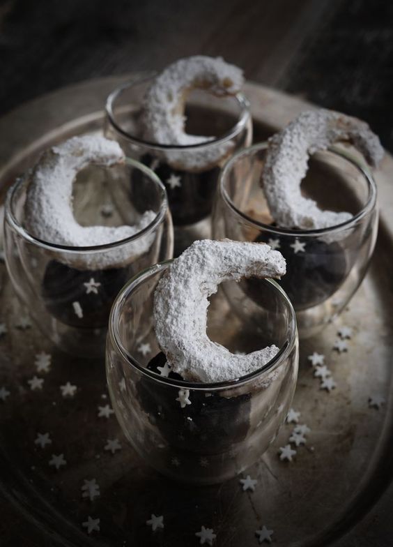 a dark planet and a shiny half moon cookie is a creative dessert for your wedding guests