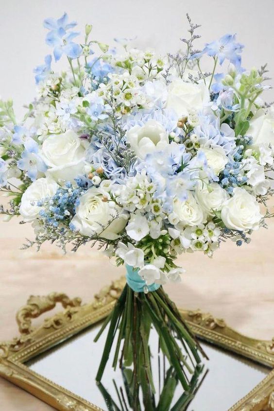 a delicate wedding bouquet of white and blue blooms and nothing else can be composed by you yourself easily