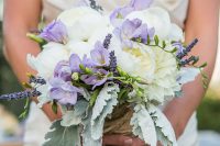 a delicate wedding bouquet of white peonies, lilac freesia, lavender and pale leaves is a cool idea for spring or summer