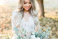 a dimensional and chic pastel wedding bouquet of serenity blue, mauve and white blooms and some eucalyptus and ribbons is wow