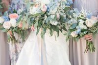 a dimensional and textural wedding bouquet with blush peonies, blue delphinium, greenery and white blooms is chic