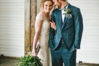 a grey suit, a light grey bow tie, a messy man bun to highlight the rustic style of the groom