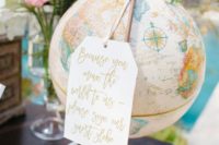 a large globe with a large tag is a nice wedding decoration and it can double as a wedding guest book, too