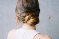 a messy low bun with twists and some hair down is great for a modern bride