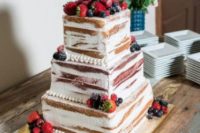a naked wedding cake with fresh berries is a simple and cute idea for a summer wedding