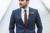 a navy blazer, a white button down, a burgundy tie, navy jeans for a chic yet relaxed groom’s look