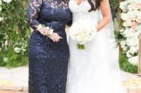 a navy lace fitting mother of the bride dress with an illusion neckline, long sleeeves for a classic and chic look