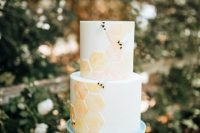 a neutral wedding cake with orange and yellow honeycombs and some black touches is a lovely idea for the summer