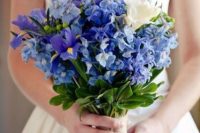 a pretty wedding bouquet done in blue and white, with irises plus a burlap wrap is a lovely idea for a rustic wedding