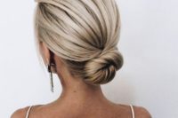a sleek low bun with a bump is a cool idea is a great option for a minimalist or modern bride