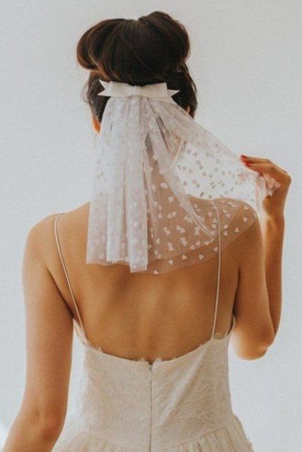 a small heart-print veil and a bow to accent a top knot is a very pretty and girlish idea to rock