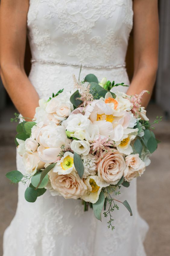 a subtle wedding bouquet of blush roses, white freesias, greenery and lisianthus is a lovely idea for a delicate spring or summer wedding