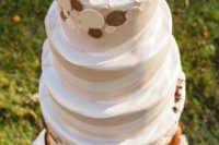 a textural buttercream wedding cake with coffee beans and a cup on top plus coffee-inspired detailing