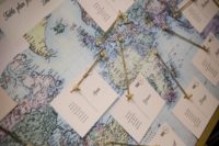 a wedding seating chart styled as a world map with some cards is a creative idea for a travel-themed wedding