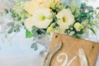 a wedding table number made of a plywood piece and a horseshoe is a cool idea in rustic style