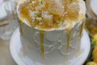 a white textural wedding cake topped with white wildflowers and honeycombs is amazing for a summer wedding