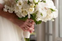a white wedding bouquet made of roses, garden roses and freesias is a lovely idea for a modern bride who loves neutrals