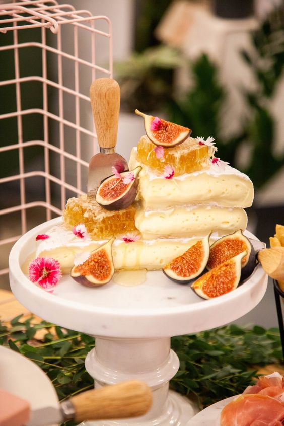 an alternative wedding cake of cheese stacked, with honeycombs and figs and bold blooms is a fantastic idea for a wedding