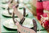 card holders made of horseshoes and cards are a simple and cute rustic wedding decor idea