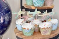cupcakes put in map liners and topped with cool map toppers shaped as planes