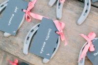 horseshoes with chalkboard tags can double as wedding favors and seating cards at the same time