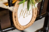 mark your wedding chairs with gold horseshoes and signs plus greenery instead of usual signs