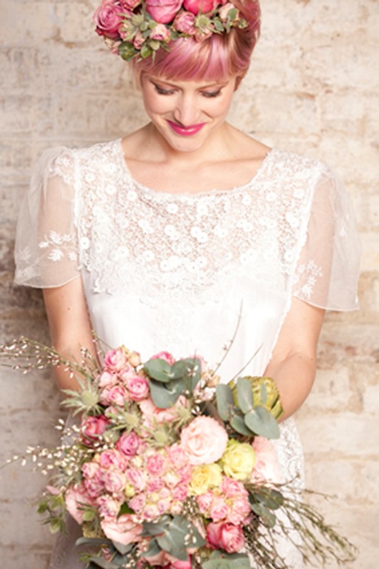 pink short hair with a fringe and pink blooms on top for accessorizing this romantic lace wedding dress