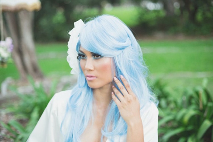 long blue hair plus a white fabric bloom as a headpiece for a mermaid-like look is a very refined idea