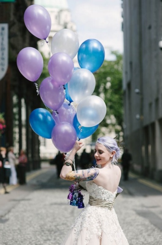lilac hair in an updo and tattoos shown off for a bold and very personalized bridal look