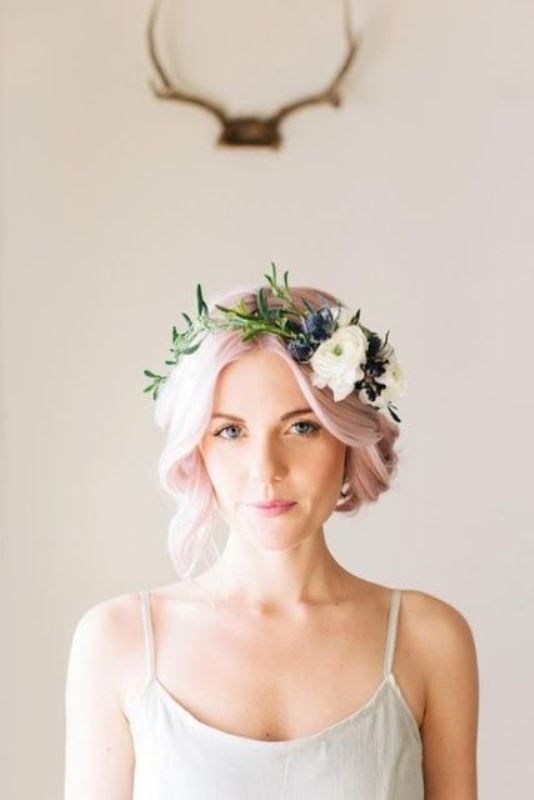 light pink hair in a wavy updo with a neutral floral crown with greenery for a relaxed boho spring or summer look