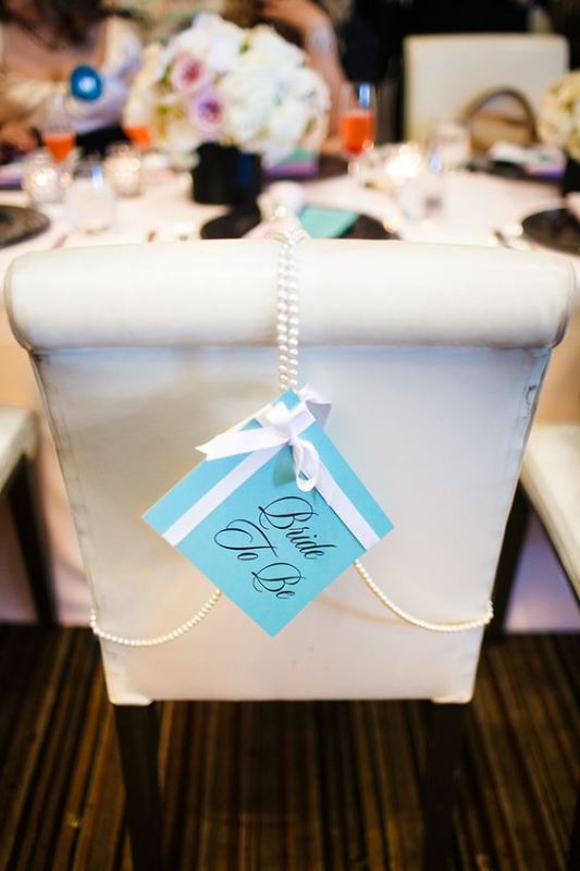 mark the bride's-to-be chair with a tiffany blue sign, a bow and pearl strands