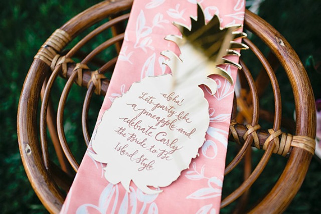 a tropical bridal shower invitation styled as a half pineapple with calligraphy