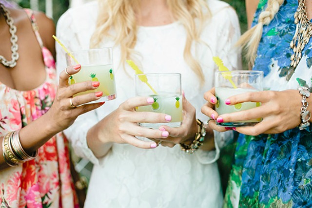 glasses with pineapple stickers and bright yellow cocktail stirrers for a tropical bridal shower