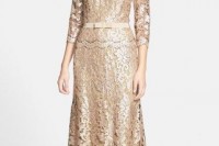 a shiny nude lace sheath maxi dress with a high neckline and short sleeves plus a belt