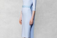 a light blue sheath wedding dress with short sleeves, a deep neckline and a capelet for a more formal feel
