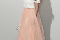 a whimsy outfit with a shiny white crop top and a peachy full tulle maxi skirt plus a silver clutch