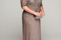 a heavily embellished taupe maxi dress with short sleeves, statement earrings and clutch