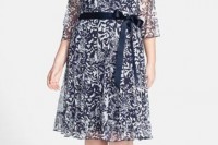 a navy and white botanical print knee dress with short sleeves and a sash to accent the waist