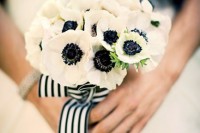 a white anemone wedding bouquet with a striped bow and cover in the matching colors is a bold modern idea to rock