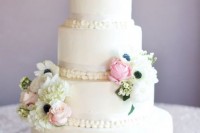 a white buttercream wedding cake decorated with white anemones and hydrangeas plus pink roses is a lovely idea for a spring or summer wedding