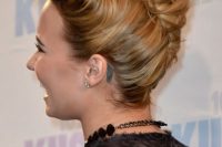 a crazy and messy French twist updo with a voluminous bang fixed up and a messy chignon