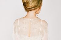 a messy French twist updo with a volume on top and some locks down for medium length hair