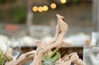 a coastal wedding centerpiece of driftwood and air plants is a lovely idea for a wedding, you can compose one yourself
