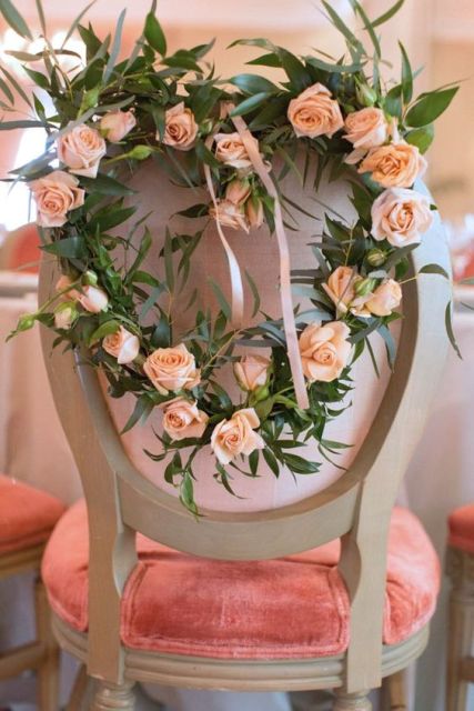 decorate your chairs with a pink heart shaped wreath of blooms to make them cuter