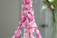 an Eiffel Tower covered with pink blooms is an unxpected and very cute decoration for a Parisian-themed bridal shower