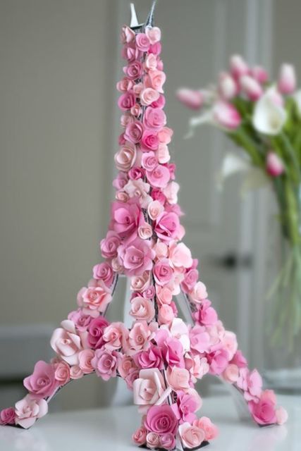 an Eiffel Tower covered with pink blooms is an unxpected and very cute decoration for a Parisian-themed bridal shower